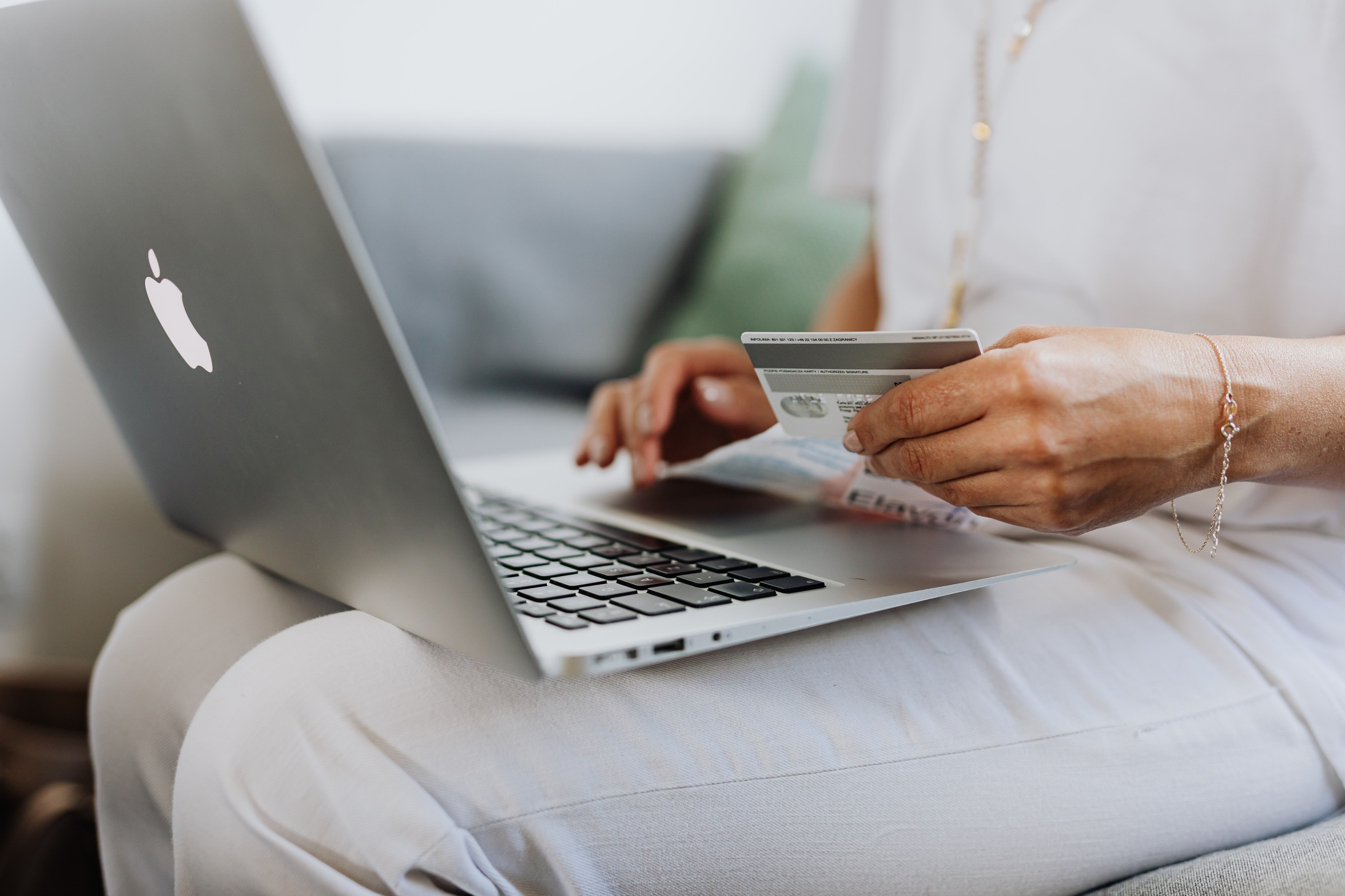 Person using a card while shopping online